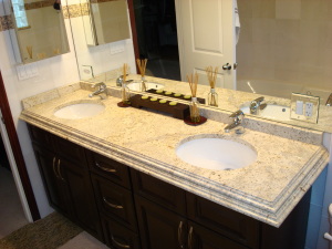 A colonial cream granite bathroom countertop and vanity mirror